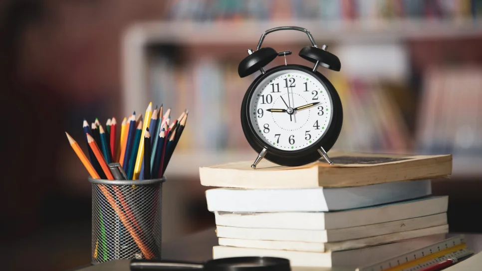 book-laptop-pencil-clock-wooden-table-library-education-learning-concept_1600x1068