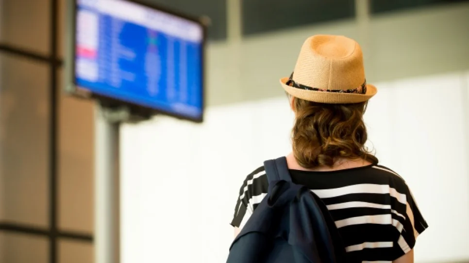 woman-looking-screens-airport_1163-709